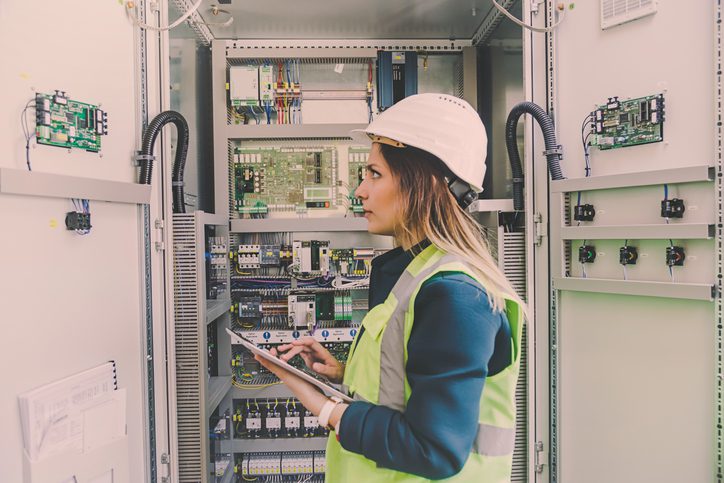 Polk Electric LLC | Female stationary engineer take notes at energy control room